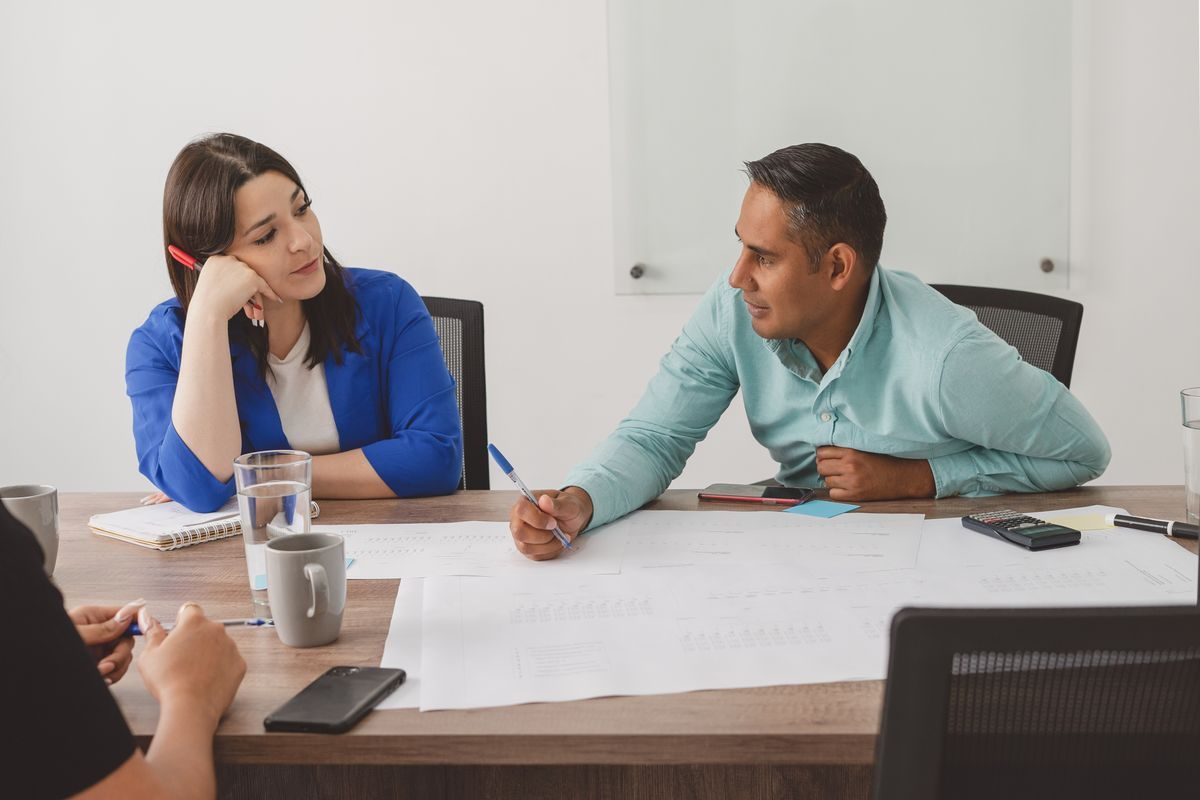 Two people working side by side
